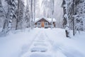 fresh footprints leading up to a secluded forest lodge in snow