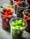 Fresh forest berries in the glasses. On stone table. Royalty Free Stock Photo