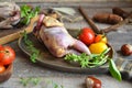 Fresh raw fowl partridge and ingredients in wooden plate on the dark kitchen table