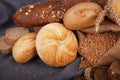 Fresh fragrant bread on the table. Food concept. Bakery, crusty loaves of bread and buns. Assortment of baked bread