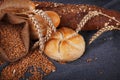 Fresh fragrant bread on the table. Food concept. Bakery, crusty loaves of bread and buns. Assortment of baked bread