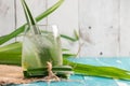 Fresh Fragrant Pandan Ice Tea and leaves on wood background