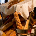 Fresh French baguettes with cereals in a silver bucket on the ba Royalty Free Stock Photo