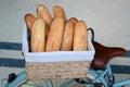 Fresh french breads, baguettes in a basket on a bicycle