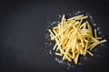 Fresh french fries with salt on black plate , top view copy space - Tasty potato fries for food or snack delicious Italian meny