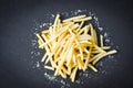 Fresh french fries with salt on black plate , top view copy space - Tasty potato fries for food or snack delicious Italian menu