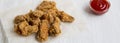 Fresh fried chicken wings with ketchup, side view. Close-up Royalty Free Stock Photo