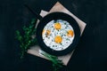 Fried eggs in cast iron frying pan on dark wooden background Royalty Free Stock Photo