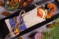 Fresh fried prawns roll with fresh tomatos, salad, cheese and onions  on bright blue background. top view. selective focus Royalty Free Stock Photo