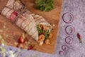 Fresh fried prawns roll with fresh tomatos, salad, cheese and onions isolated on bright blue background. top view. selective focus Royalty Free Stock Photo