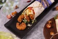 Fresh fried prawns roll with fresh tomatos, salad, cheese and onions isolated on bright blue background. top view. selective focus Royalty Free Stock Photo