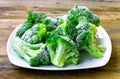 Fresh frozen broccoli on white plate