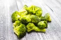 Fresh frozen broccoli on a wooden background, healthy diet, close-up Royalty Free Stock Photo