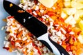 Fresh and frozen chopped vegetables,  Chopped carrots, potatoes, onions and red bell pepper on white cutting board Royalty Free Stock Photo