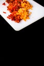 Fresh and frozen chopped vegetables,  Chopped carrots  and red bell pepper on white cutting board Royalty Free Stock Photo