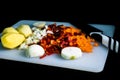 Fresh and frozen chopped vegetables,  Chopped carrots, potatoes, onions and red bell pepper on white cutting board Royalty Free Stock Photo