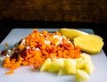 Fresh and frozen chopped vegetables,  Chopped carrots, potatoes, onions and red bell pepper on white cutting board Royalty Free Stock Photo