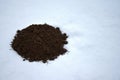 Fresh frozen mole molehill on winter time snow