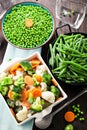 Fresh frozen vegetables on wooden background close up Royalty Free Stock Photo