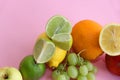 Fresh fruit apple, lime, avocado, lemon, orange, grapes on a light pink background Royalty Free Stock Photo