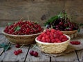 Fresh fruit and berries in baskets on wooden background Royalty Free Stock Photo