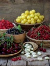 Fresh fruit and berries in baskets on wooden background Royalty Free Stock Photo