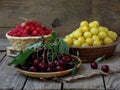 Fresh fruit and berries in baskets on wooden background Royalty Free Stock Photo