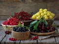 Fresh fruit and berries in baskets on wooden background Royalty Free Stock Photo