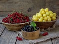 Fresh fruit and berries in baskets on wooden background Royalty Free Stock Photo