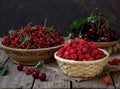 Fresh fruit and berries in baskets on wooden background Royalty Free Stock Photo