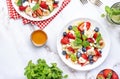 Fresh fruit and berry salad with cottage cheese, strawberries, blueberries, kiwis, oranges and mint leaves with honey dressing, Royalty Free Stock Photo