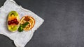 Fresh fruit and berry tart dessert with toss sugar. Delicious sweet cake with kiwi, orange and cherry on a shale board. top view, Royalty Free Stock Photo