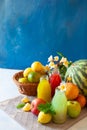 Fresh fruit, berry and vegetable juices on bright blue background.Homemade refreshing beverage