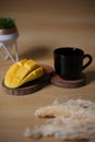 Fresh fruit and black cup on wooden background