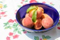 Fresh fruit in a blue bowl on a table Royalty Free Stock Photo