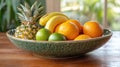 Fresh fruit bowl with pineapple, bananas, oranges, and limes Royalty Free Stock Photo