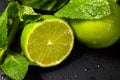 Fresh fruit close-up. Lime and mint leaves on a dark background Royalty Free Stock Photo