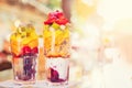 Fresh fruit cocktail finely chopped orange slices, strawberries, kiwi, yogurt, oatmeal. Concept health is refreshing and Royalty Free Stock Photo