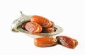 Fresh fruit dates in a silver metal bowl on isolated white background