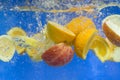 Fresh fruit falling in water Royalty Free Stock Photo