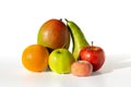 fresh fruit group - apple green and red, pear, mango and orange, lie on a white table, isolated Royalty Free Stock Photo