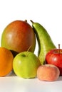 fresh fruit group - apple green and red, pear, mango and orange, lie on a white table, isolated Royalty Free Stock Photo