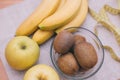 Fresh fruit kiwi, apples, bananas on the table