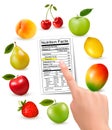 Fresh fruit with a nutrition facts label and hand. Royalty Free Stock Photo