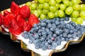 Fresh fruit platter with arranged organic blueberries, strawberries, grapes on banquet table at business or wedding event Royalty Free Stock Photo