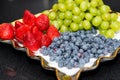 Fresh fruit platter with arranged organic blueberries, strawberries, grapes on banquet table at business or wedding event Royalty Free Stock Photo