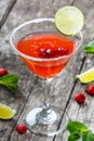 Fresh fruit raspberries cocktail with lime in glass on wooden background. Summer drinks and alcoholic cocktails Royalty Free Stock Photo