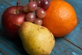 Fresh fruit red apple pear orange and grapes Royalty Free Stock Photo