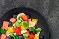 Fresh fruit salad on black plate. Top view Royalty Free Stock Photo