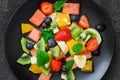 Fresh fruit salad on black plate. Top view Royalty Free Stock Photo